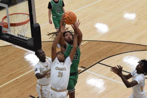 D.J. Appleby grabs a rebound over a Commerce player Thursday in a game at Commerce.
