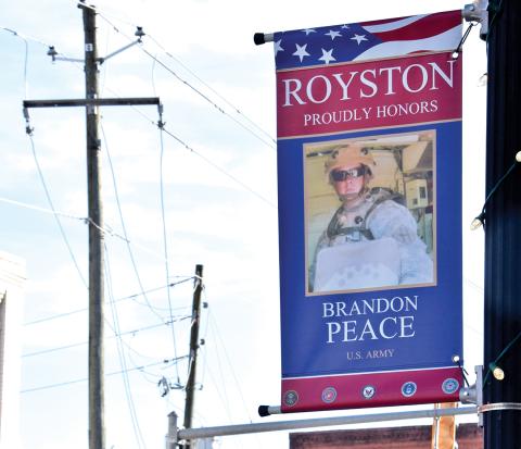 Banners bearing the faces of just some of those who have served in the U.S. armed forces are now on display in downtown Royston.