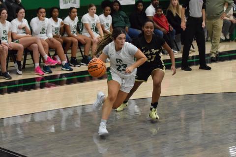 Bella Rosene drives to the basket against Commerce Thursday in the Lion’s Den. Rosene had 14 points in the game. (Photos by Scoggins)