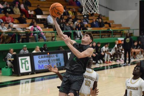 Carson Coulter goes in for a layup Thursday against Commerce in the Lion’s Den. (Photo by Scoggins)
