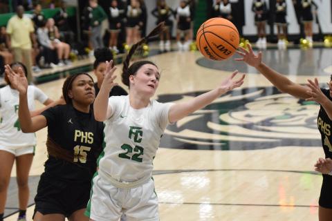 Avery Burton reaches for a rebound Tuesday in action against Pendleton, S.C., in the Lion’s Den. (Photo by Scoggins)