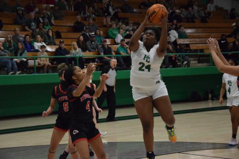 Ta’kiyah Merriett (right) collects a rebound.