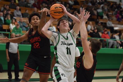 Bentley Huff goes up between two Stephens County defenders for a layup in Friday’s Franklin County Lion blowout of the Indians in Carnesville. (Photo by Scoggins)
