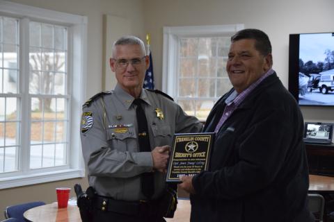 Sheriff Scott Andrews (left) presents a plaque of appreciation to Investigator Jimmy LeCroy, who retired Tuesday, after 38 years of service with the Franklin County Sheriff’s Office. (Photo by Scoggins)