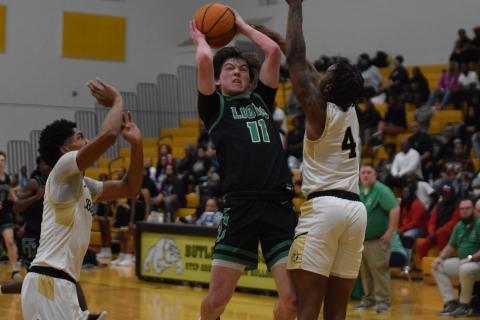 Bentley Huff (above) grabs a loose ball in action against Butler last week in the state quarterfinals against Butler in Augusta.