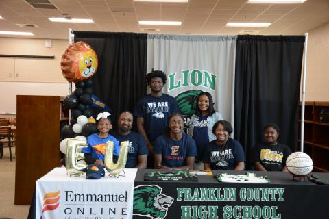 Franklin County High School senior Mylan Roebuck was surrounded by family and friends when he signed his scholarship to play basketball for Emmanuel University on Tuesday. Members of his family there for the occasion were (front, from left) Aubree Roebuck, Bernard Roebuck, Mylan, D’Anna Roebuck, Amiracle Roebuck, (back) Micah Roebuck and Alexus Burton. Mylan will join his brother Micah on the Emmanuel Lions basketball team. (Photo by Eavenson)