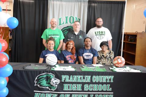 Franklin County senior Frae’Quane Wilkins signed a scholarship Friday to play basketball at Southwestern Community College in Iowa. Taking part in the signing ceremony were (front, from left) sister Sherika Willis, mother Lashanda Willis, Wilkins, grandmother Chris Heard, (back) coaches Josh Smith, Head Coach Jason Shaver and Josh Bentley. (Photo by Eavenson)