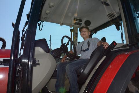 14-year-old Heaton Williams sits in his Massey Ferguson tractor that he uses ion his family’s farm and to bush hog fields and harvest corn for local farmers. (Photo by Charlie Eavenson)