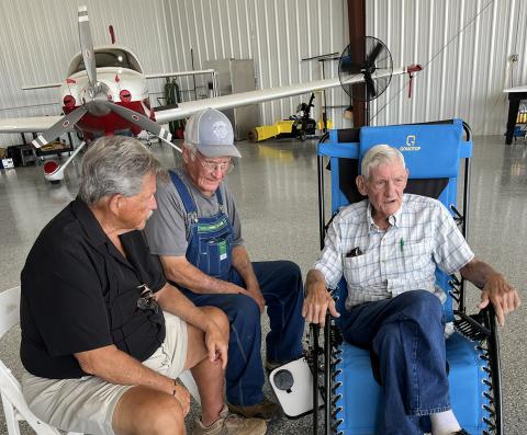 George Bennett (above photo, right) talks with State Rep. Alan Powell (left) and Tim Kennedy during a ceremony Sunday at the Franklin-Hart County Airport.