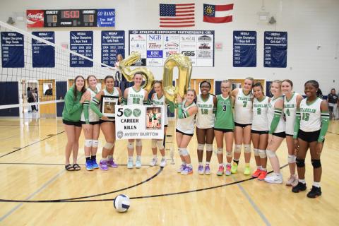 ELBERTON – Members of the Franklin County Lady Lion volleyball team took time out during a game Tuesday against Rabun County in Elberton to congratulate junior Avery Burton for her 500th career kill. The team went on to defeat Rabun County and Elbert County. For complete details, see Page 11. (Photo by Shane Scoggins)
