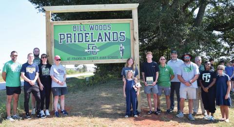 Members of the Wood family were joined Thursday by Franklin County School System officials and cross-country and track coaches for the dedication of the Bill Woods Pridelands Cross Country Course on High Road in Carnesville. (Photo by Shane Scoggins)