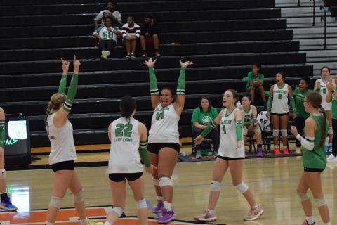 Lady Lion Kallie Thrift (No. 14) celebrates with teammates Callie Frady and Avery Burton after winning a point in Franklin County’s Region 8AA semifinal win over Hart County last week. The win qualified Franklin for the state playoffs for the first time in school history. (Photo by Shane Scoggins)