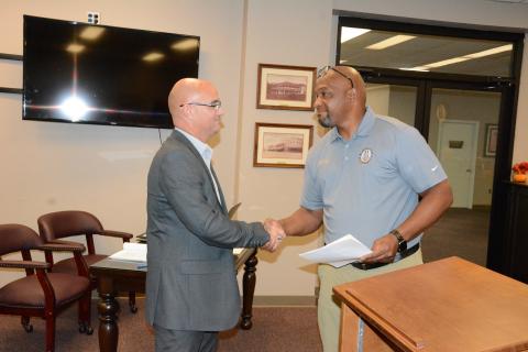 Royston Mayor Keith Turman (right) shakes hands with new Council Member Jared Hightower Tuesday after a swearing-in ceremony at Royston City Hall. Hightower then joined the council for its regular monthly meeting. (Photo by Charlie Eavenson)