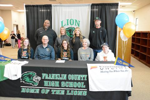 Hayden McGee signed her scholarship to play softball for Emmanuel University while her coaches and family looked on. Those in attendance were (seated, from left) sister Ava McGee, father Bruce McGee, Hayden, mother Laura McGee, brother Brooks McGee, (back) Coach Demond Rivers, head coach Cherokee Bell, Coach Kendsey Chappelear and Coach Tim Cawthon.