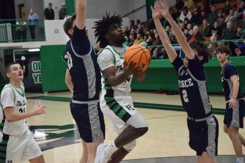 Jeremiah Mayfield goes up for a layup between two Prince Avenue defenders in Franklin County’s home victory Friday. (Photo by Shane Scoggins)