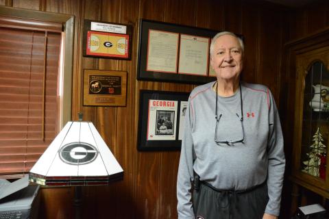 Roy Holland of Lavonia stands with some of his awards and honors he garnered as a basketball letterman for the University of Georgia Bulldogs. (Photo by Charlie Eavenson)