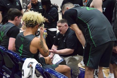 Coach Jason Shaver gives his team instructions during a timeout in the Region 8AA championship game Friday at Prince Avenue Christian School in Bogart.