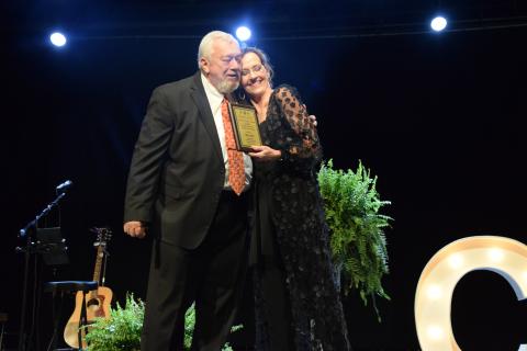 Sid Ginn hugs Franklin County Chamber of Commerce Director Rachel Howington after receiving the Charles E. Bradshaw Citizen of the Year Award.