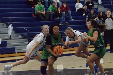 Senior Ta’Kiah Winkfield gets by two Coahulla Creek defenders on her way to the basket in a Sweet 16 game in Dalton Friday. (Photo by Shane Scoggins)
