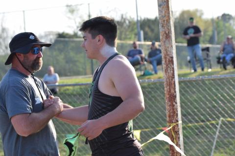 Coach Clint Tanner (left) congratulates Candler Stone after Stone broke the school record for shot put Thursday at FCHS. Tanner, who coaches Stone, set the previous record in 1999. (Photo by Shane Scoggins)