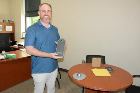 Franklin County High School Principal Curtis Chitwood shows off the school’s YONDR Pouch system to prevent the use of electronic devices during the school day. (Photo by Charlie Eavenson)