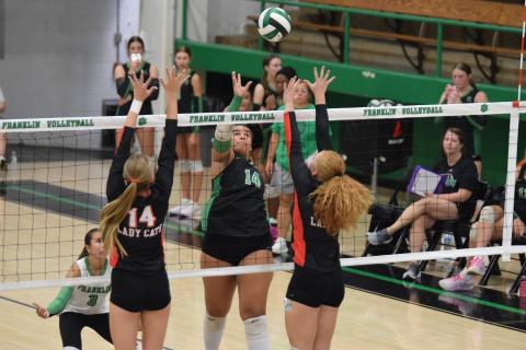 Kallie Thrift hits a ball over the net in a game earlier this year. Thrift has helped lead the team to a winning record for the season after a slow start.