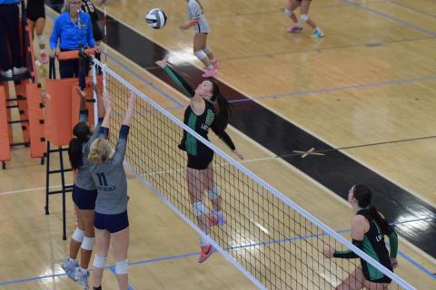 Senior Lady Lion Avery Burton jumps to push the ball across the net over two Elbert County defenders Tuesday in Region 8AAA action at Hart County High School. (Photo by Shane Scoggins)