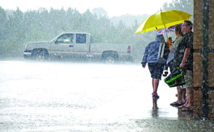 Franklin County Lion football fans first waited out a rainstorm (left) Friday but then had to line up at ticket boots for refunds after the game between Franklin County and Habersham Central was cancelled due to lightning. The game has been rescheduled for Sept. 27.