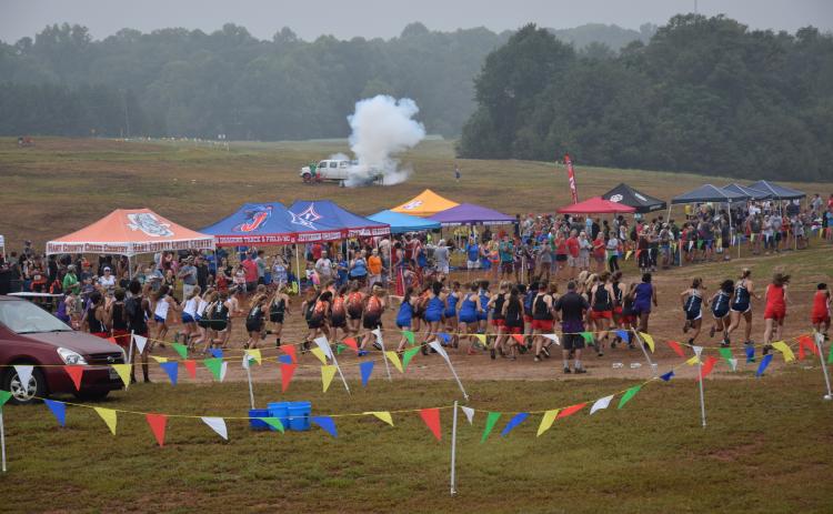 A blast from Franklin County’s touchdown canon sends runners off the start line at the Franklin County Invitational cross-country meet Saturday in Carnesville. (Photo by Scoggins)
