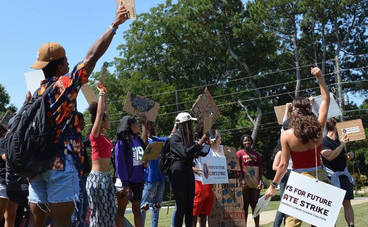 Students and members of the community took part in a Fridays for Future environmental rally Friday at Emmanuel College to bring attention to efforts to clean up the environment and combat climate change. (Photo courtesy of Trinity Duarte)