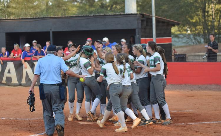 The Franklin County Lady Lions, pictured celebrating a Jaden Cheek home run during the region championship game, will host Coahulla Creek Wednesday for a doubleheader in the first round of the state tournament.