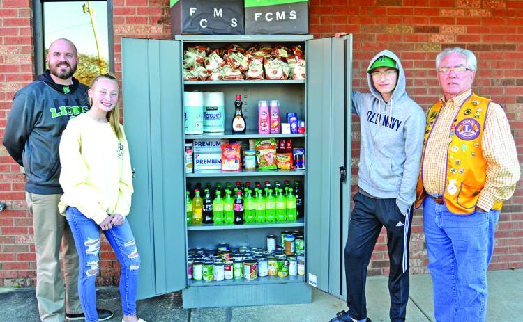 Attending the unveiling of the Franklin County Middle School Leo Club’s Take and Give Box at the Lavonia Police Department are (from left) FCMS Principal C.J. Wilder, Leo Club members Lealyn Day and Tyler Albrecht and Lavonia Lions Club member David Howell. (Photo by Eberhardt)