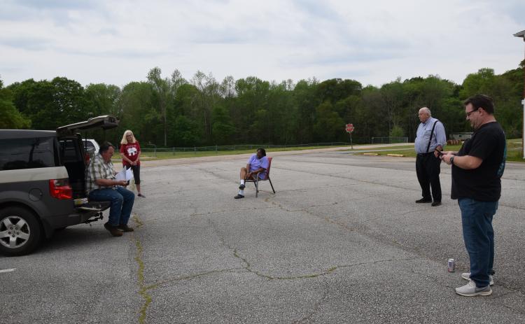 The Carnesville City Council met in the City Hall parking lot Tuesday to accept a federal grant for funding for a splash pad at the city park. (Photo by Scoggins)