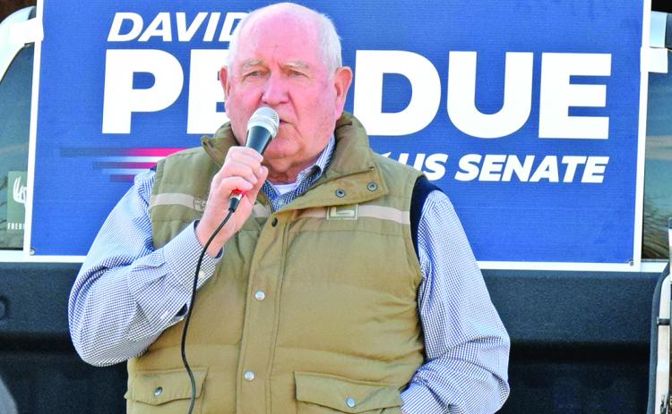 U.S. Secretary of Agriculture Sonny Perdue speaks Tuesday during a rally in Royston in support of Republican Sens. David Perdue and Kelly Loeffler. (Photo by Scoggins)