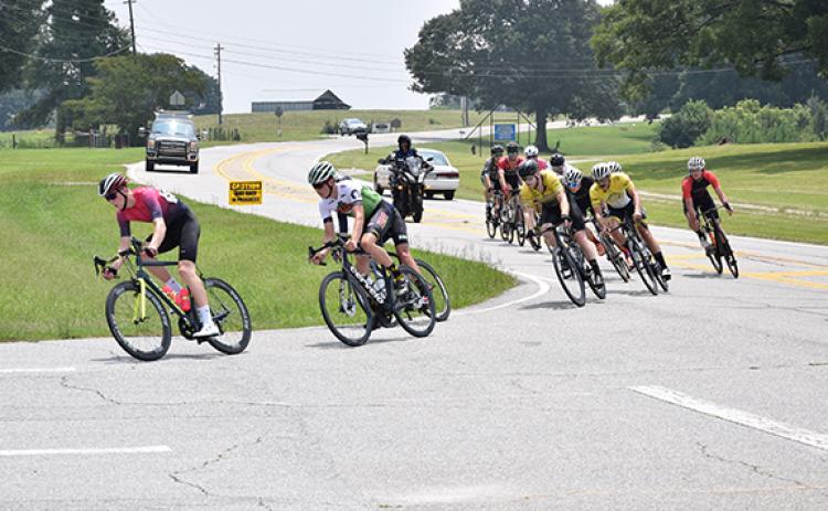 Bicycle racers make the turn into the Franklin County High School campus Sunday. (Photo by Scoggins)
