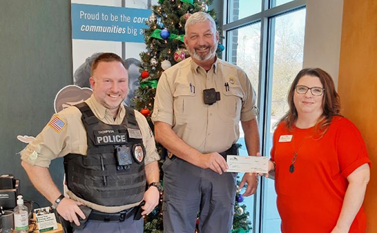 Pinnacle Bank Franklin Springs Branch Manager Carrie Brown presents a check to Franklin Springs Police Chief Jim Davis and Officer Kevin Thompson.