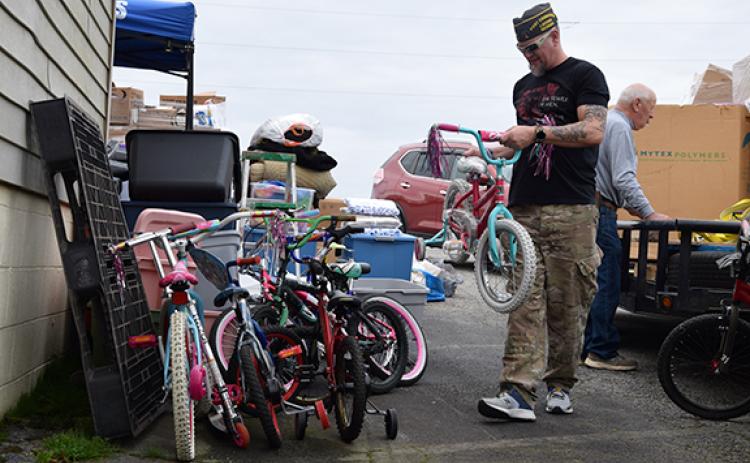 Lavonia VFW Post 5897 Commander Jason Nichols stacks bicycles that were donated to tornado victims in Mayfield, Ky., last week from Lavonia. The local post served as the statewide hub for VFW donations. (Photo by Sinclair)