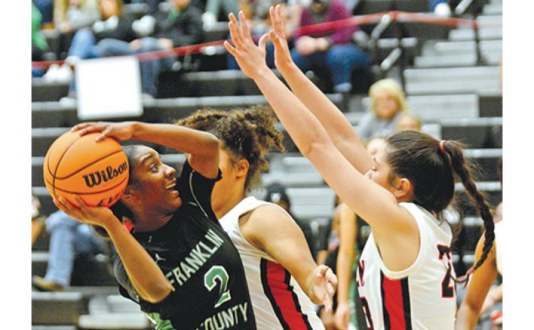 Franklin County’s Paris Gaye looks for a shot against two Stephens County defenders Friday night in Toccoa. Gaye and the Lady Lions blew out the Lady Indians 61-28 to start region play. (Photo by Scoggins)