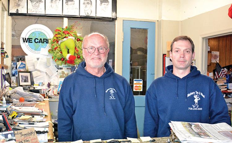 John Sullivan (left), founder of Mayberry Tire & Wheel, stands with new owner Sam Donaldson (right). Sullivan is preparing to retire from the cornerstone business in downtown Royston. (Photo by Scoggins)