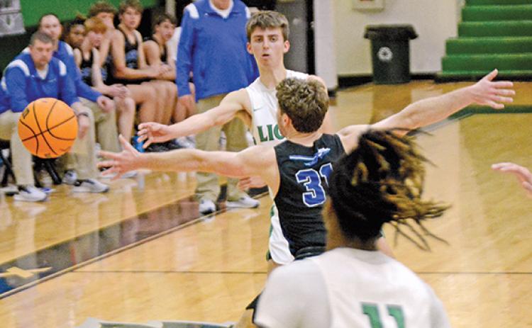 Cam Maxwell wraps a pass around an Oconee County defender to teammate David Witcher during action last week in the Lions’ Den. (Photo by Scoggins)