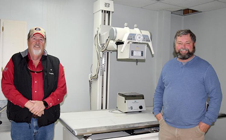Jerry “Scoot” Rice and Scott Bailey are donating x-ray machine equipment left in the former medical building they turning into a storage facility. (Photo by Sinclair)