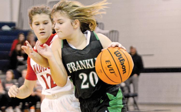 The Franklin County Middle School Lady Cub basketball teams finished their seasons Saturday in Elberton in the NEGIAA tournament. Seventh grade team member Chloe McFarlin drives past a Madison County defender. (Photo by Scoggins)