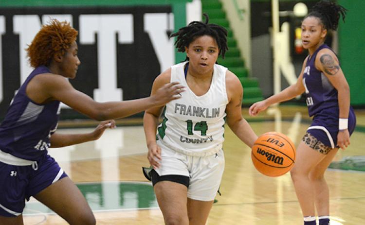 Ny’Kerriah Brown dribbles down court Tuesday in the Lady Lions’ dominant win over Monroe Area. (Photo by Scoggins)
