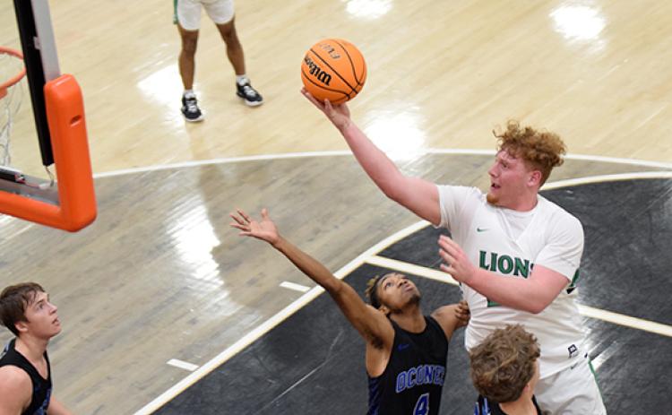 Keylan “Red” Rutledge lays in two of his 27 points in the region semifinal game Thursday against Oconee County in Hartwell. (Photo by Scoggins)