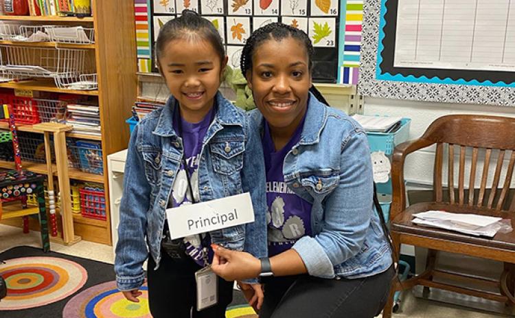 Royston Elementary School Principal Quowanna Mattox (right) poses with a student who dressed as her during a school dress-up day.