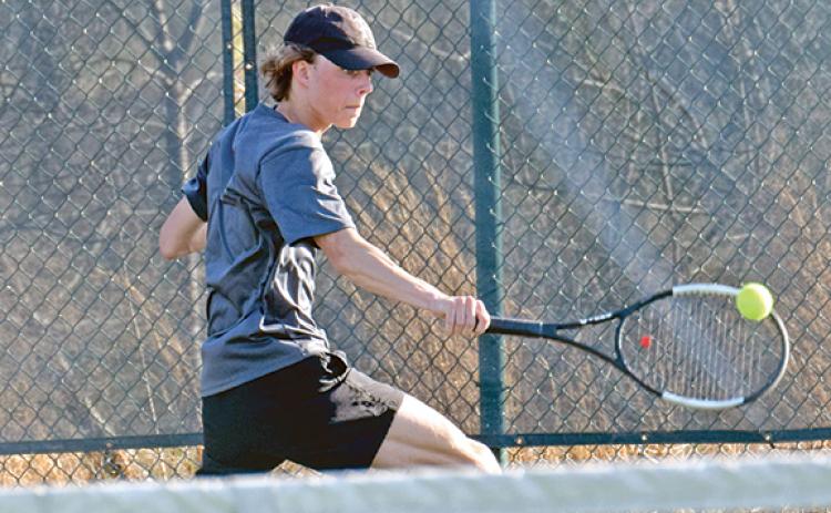 Franklin County singles tennis player Will Wester returns a ball during action last week at home against Oconee County.