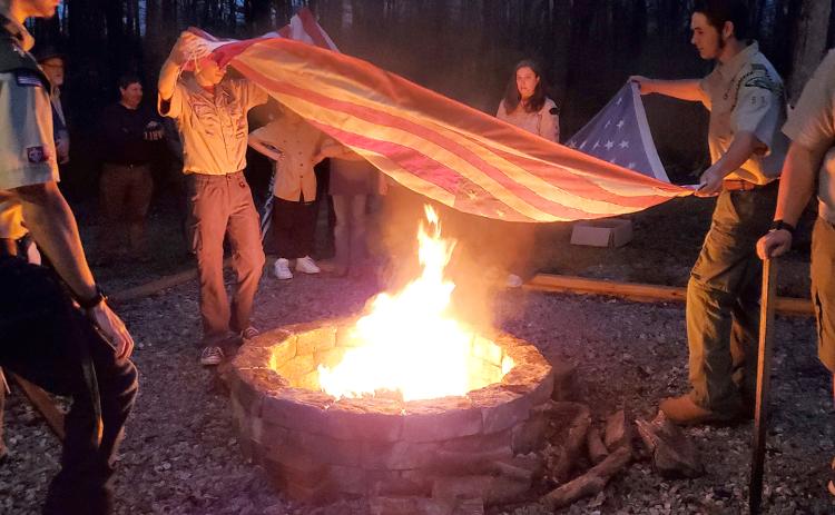 Lavonia Boy Scout Troop 51 members retire one of 15 worn American flags left in the flag retirement box during a flag retirement ceremony Monday at Lavonia Memorial Park. The ceremony was held following a fire pit dedication Monday night. Replacing the fire pit at the park was J.T. Strickland’s Eagle Scout project.