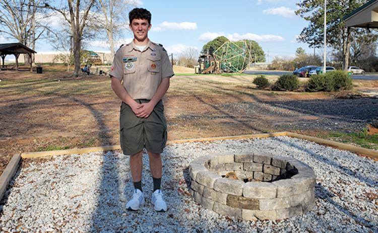 Lavonia Scout Troop 51 Eagle Scout J.T. Strickland stands beside the fire pit he built for his Eagle Scout Project. (Photo by Sinclair)