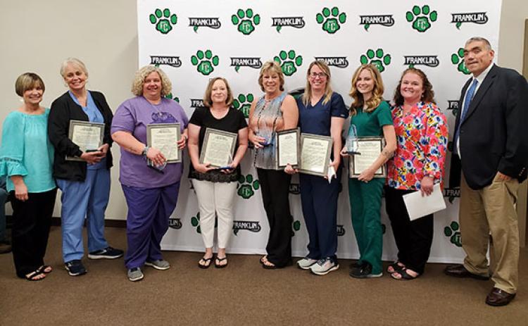 Assistant Superintendent Melanie Burton-Brown, Special Education Director Dr. Ashlee Underwood and Superintendent Chris Forrer congratulate school nurses Norina South, Carmen Jordan, Janice Holcombe, Donna Eavenson, Kayla Holland, and Anna Adams at the Franklin County Board of Education meeting Tuesday night. (Photo by Sinclair)