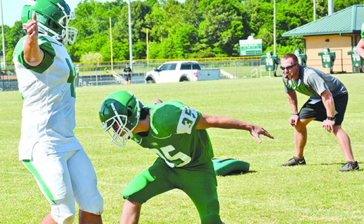 Franklin County Lion Head Coach Parker Martin (right) oversees a tackling drill during a spring practice session Tuesday at FCHS. (Photo by Scoggins)